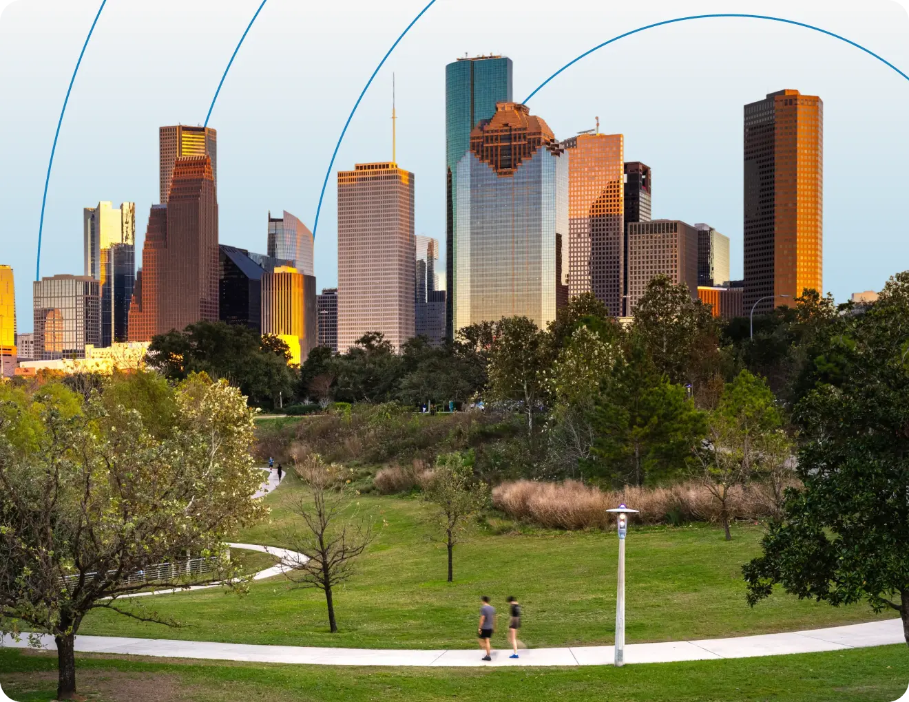 Houston skyline view from Eleanor Tinsley Park with downtown skyscrapers, green space, and walking path in foreground