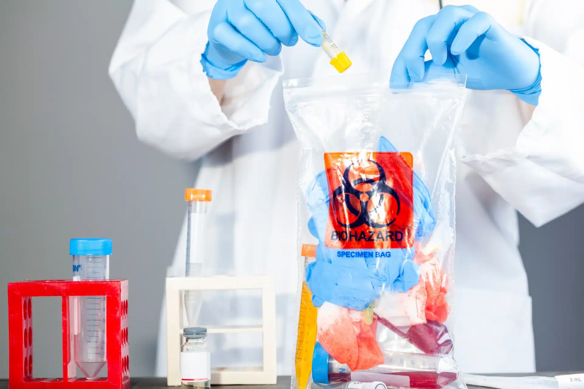 Medical waste management professional disposing of healthcare biohazard materials